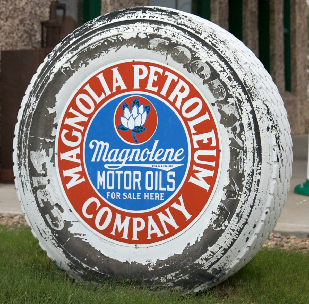 Magnolia Petroleum Company sign with a magnolia blossom and Magnolene Motor Oils lettering.