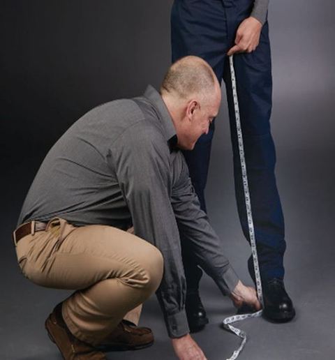Tape from the inner crotch seam down the inside of the leg with boots on.