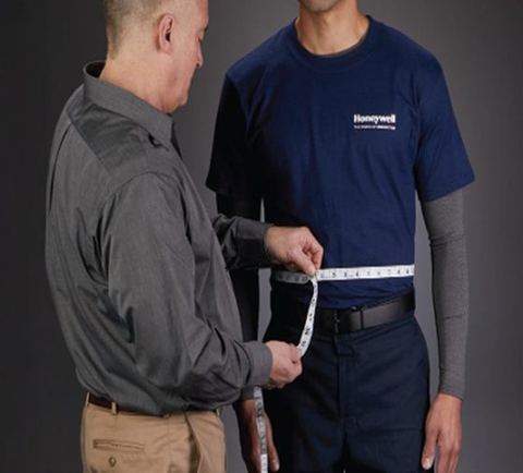 Tape held level around the waist at the navel.